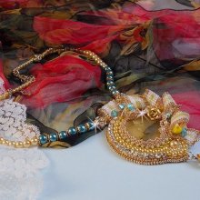 Haute-Couture Sunflower Gold pendant embroidered with 24 karat gold-plated seed beads, a Madagascar opal and Swarovski crystals.